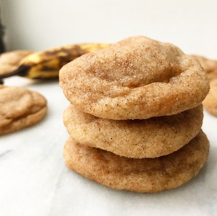 a stack of cookies sitting on top of a white table next to a ripe banana