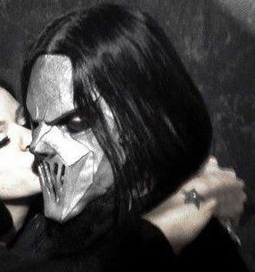 two people with makeup on their faces and one is kissing the other's face