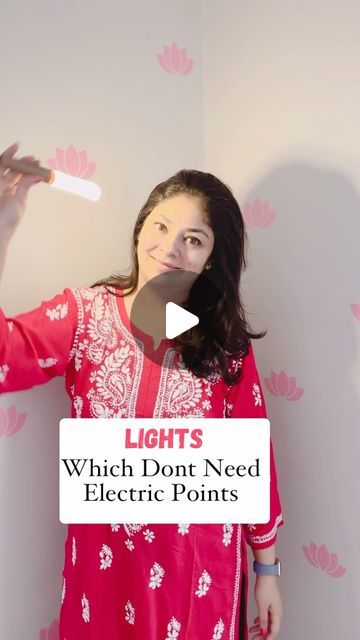 a woman in red dress holding up a white object with words that read lights which don't need electric points