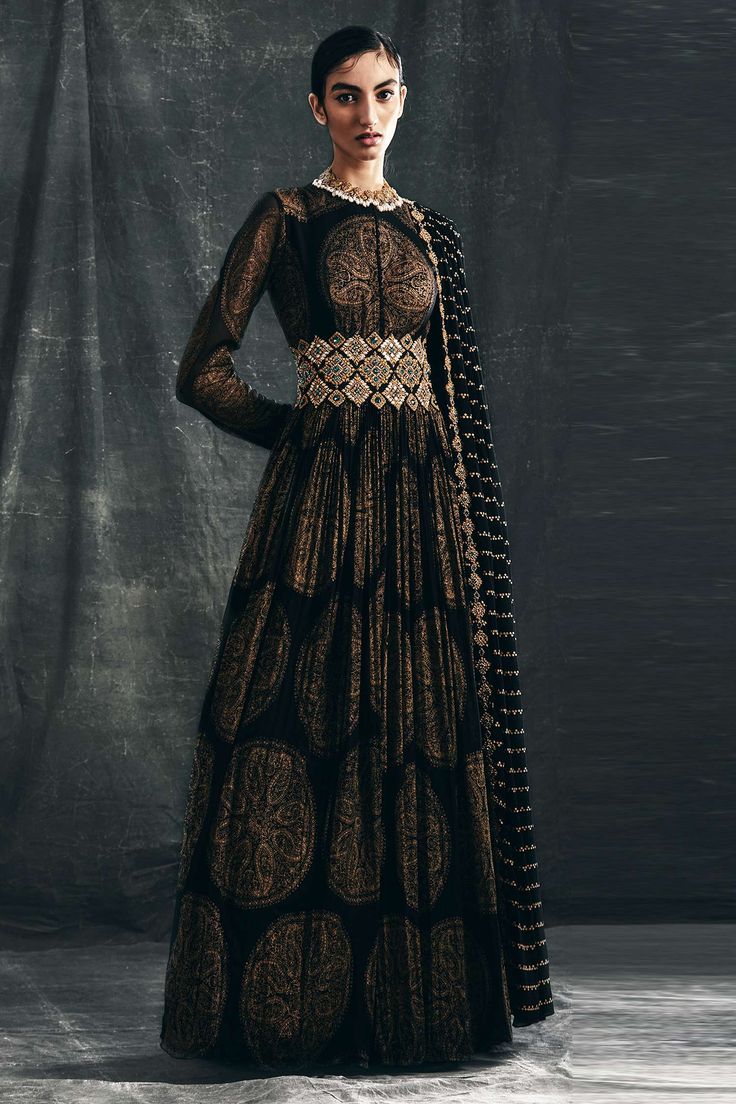 Black anarkali with gold ambi circle print all over paired with handcrafted thread-pitta embroidered belt enhanced with mirror, emerald green stone embellishments. Comes with an attached nukta print dupatta.
Component: 2
Embroidered, Printed
Neckline: Round
Sleeve Length: Full
Fabric: Georgette
Color: Black
Attached dupatta
Churidar sleeves
Potli buttons
Cutwork border
Tassel tie-up belt
Note: Necklace worn by the model is not for sale - Aza Fashions Anarkali With Belt, Pitta Embroidery, Gold Anarkali, Bhumika Sharma, Potli Button, Casual Bridal Dress, Anarkali With Dupatta, Black Anarkali, Emerald Green Stone