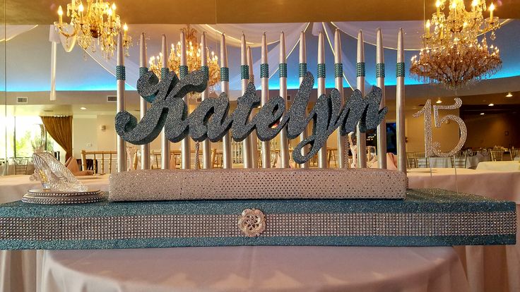 a cake that is sitting on top of a table with candles in the shape of letters