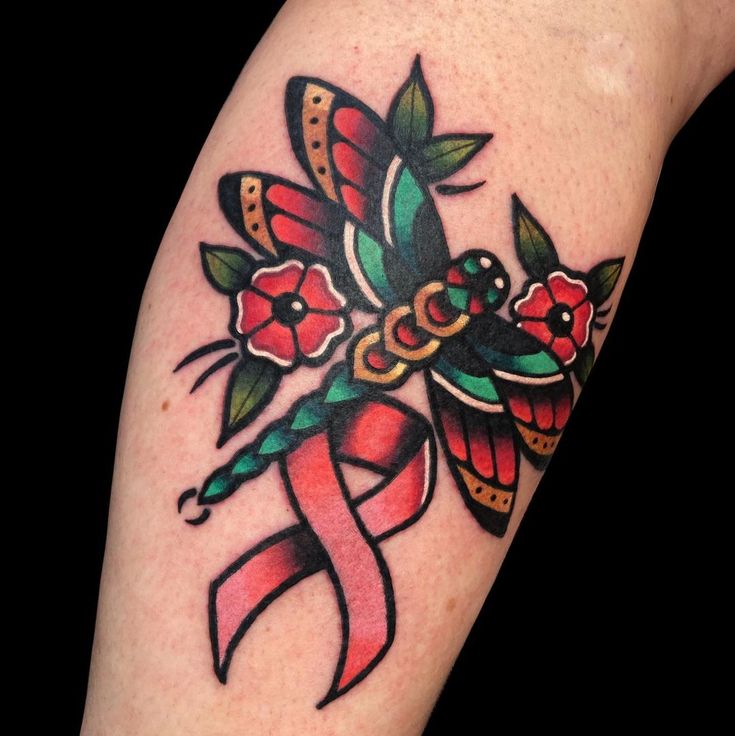 a colorful tattoo design on the arm of a woman with flowers and ribbons around her ankles