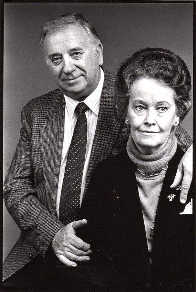 an older couple posing for a black and white photo