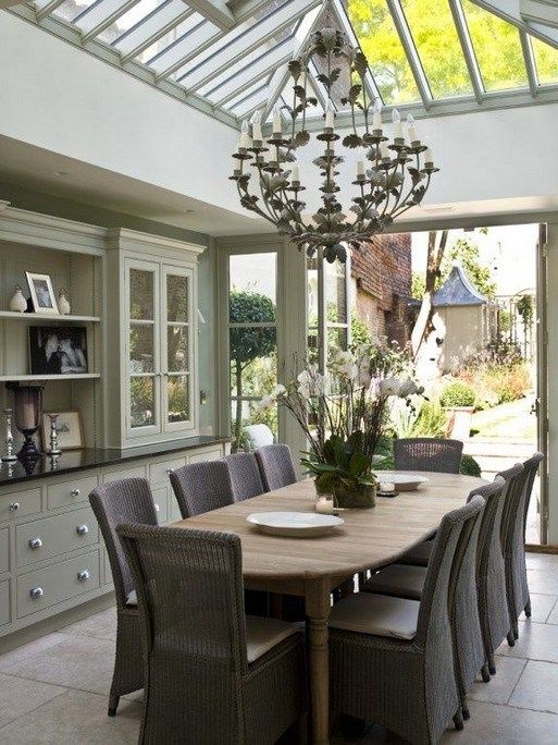 the dining room table is surrounded by wicker chairs