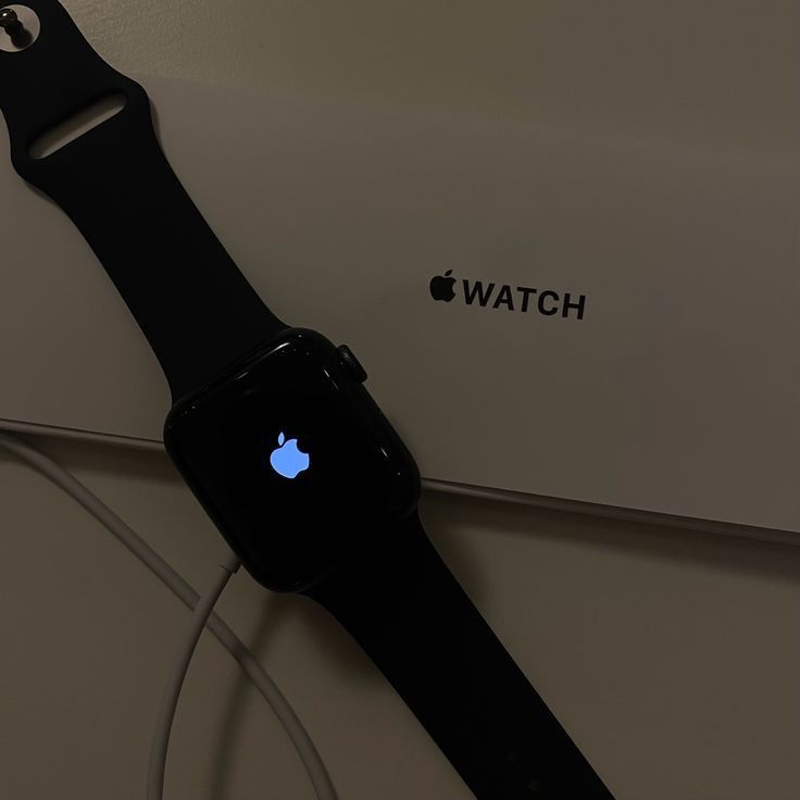 an apple watch sitting on top of a white box