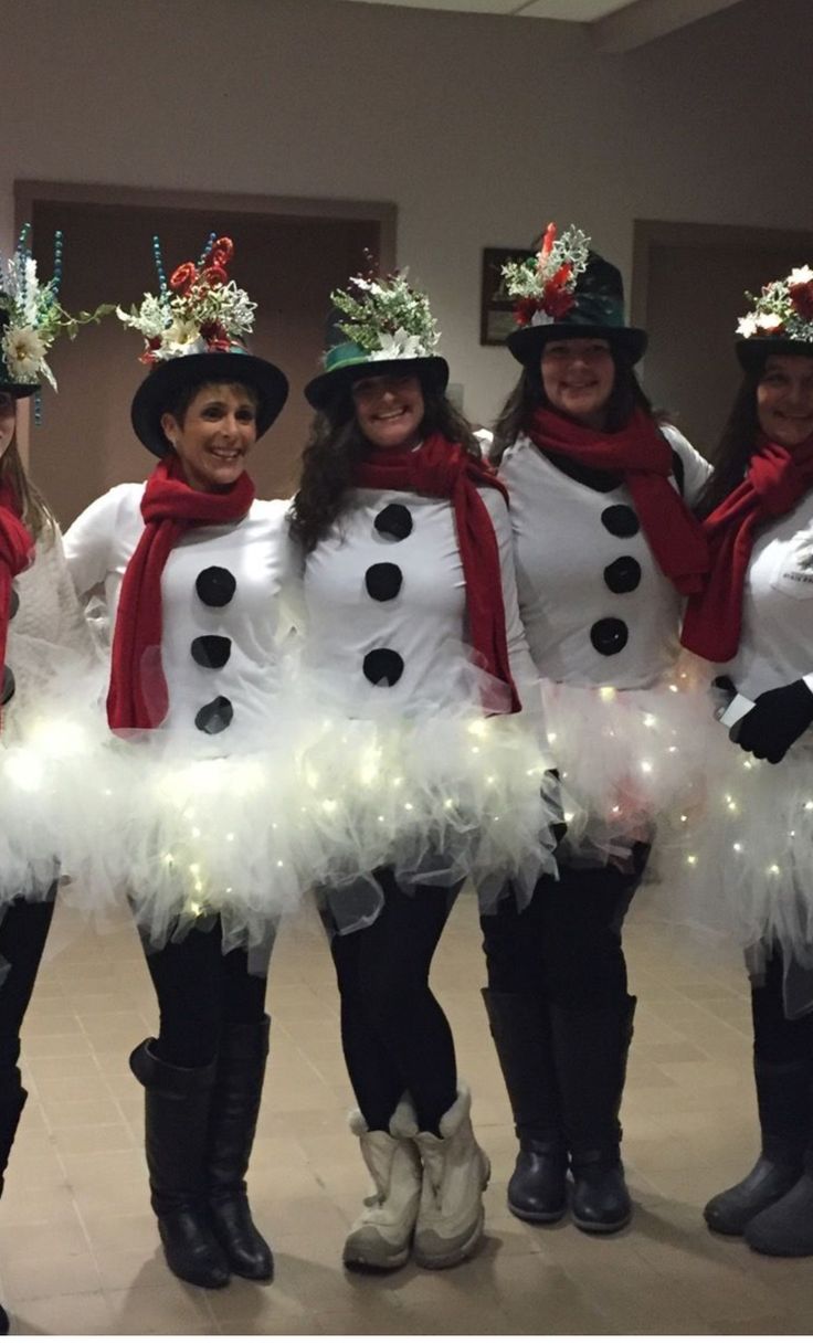 four women dressed up in snowmen costumes