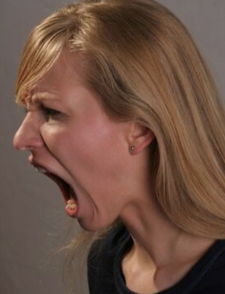 a woman screaming with her mouth open