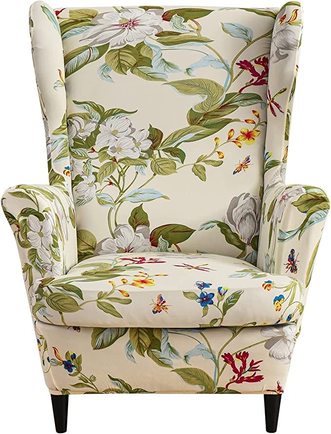 a white chair with flowers on it and green leaves around the armrests, sitting in front of a white background