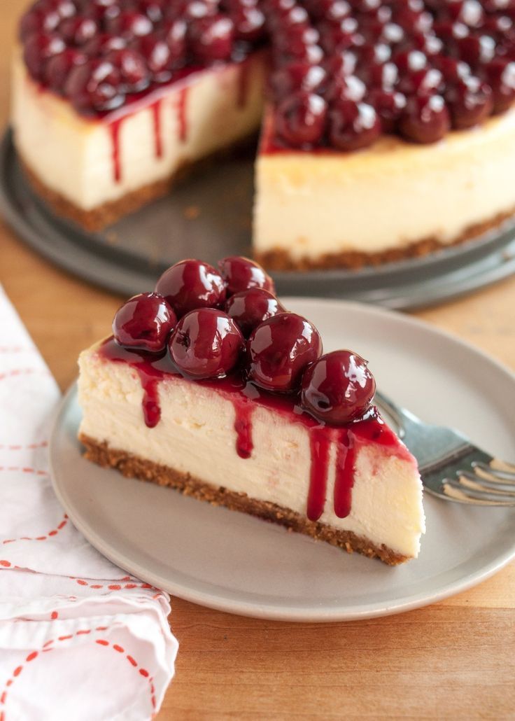 a piece of cheesecake with cherries on top