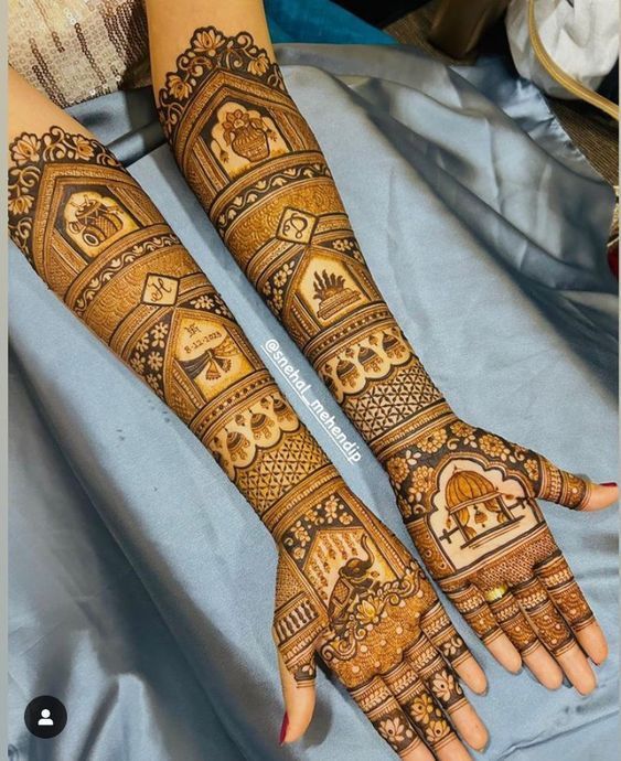 two hands with henna designs on them, one is showing off the intricate design