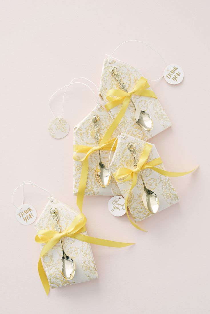 spoons and tags tied together with yellow ribbon