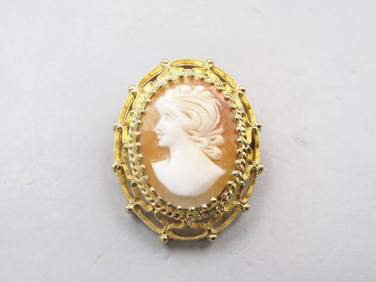 Beautiful Edwardian 14k Yellow Gold Shell Carved Cameo Brooch Pin Pendant in Filigree Frame. The piece is in excellent condition. It can be worn as a pin or a pendant. The 14k solid gold filigree frame. It is 1 1/4" tall and 1" wide. It weighs 6.6 grams. The cameo is Very attractive antique piece of jewelry. Great gift idea. Formal Gold Cameo Brooch, Formal Gold Cameo Brooches, Gold Cameo Brooch For Wedding, Gold Cabochon Brooch For Wedding, Gold Wedding Brooch With Cabochon, Gold Cabochon Brooches For Wedding, Gold Wedding Brooches With Cabochon, Filigree Frame, Carved Shell