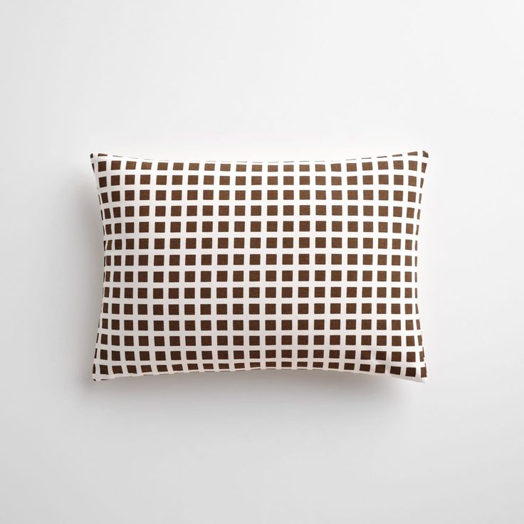 a brown and white pillow sitting on top of a table