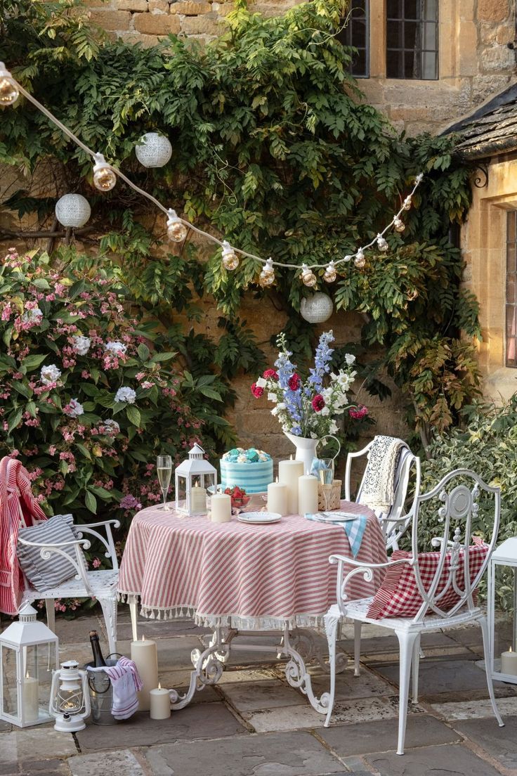 an outdoor table and chairs are set up outside