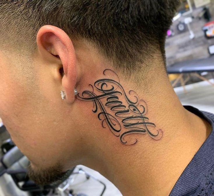 a man with a tattoo on his neck has the word faith written in cursive font