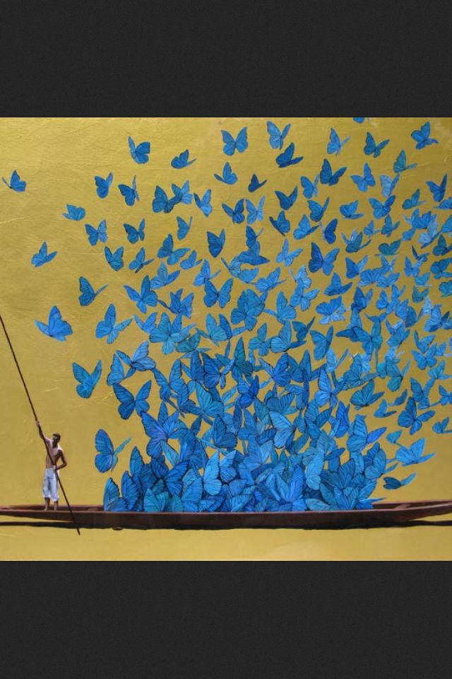 a man standing on a boat with blue butterflies in the air above him and holding a fishing pole