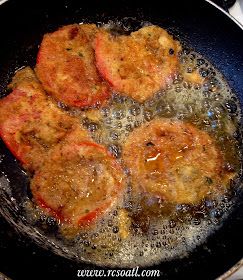 some meat patties are cooking in a frying pan on the stove with oil