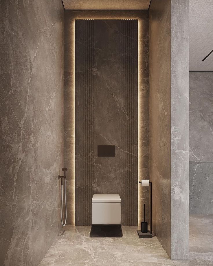 a modern bathroom with marble walls and flooring, along with a white toilet in the middle