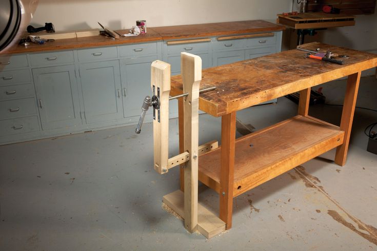 a workbench in the middle of a room with lots of cabinets and drawers