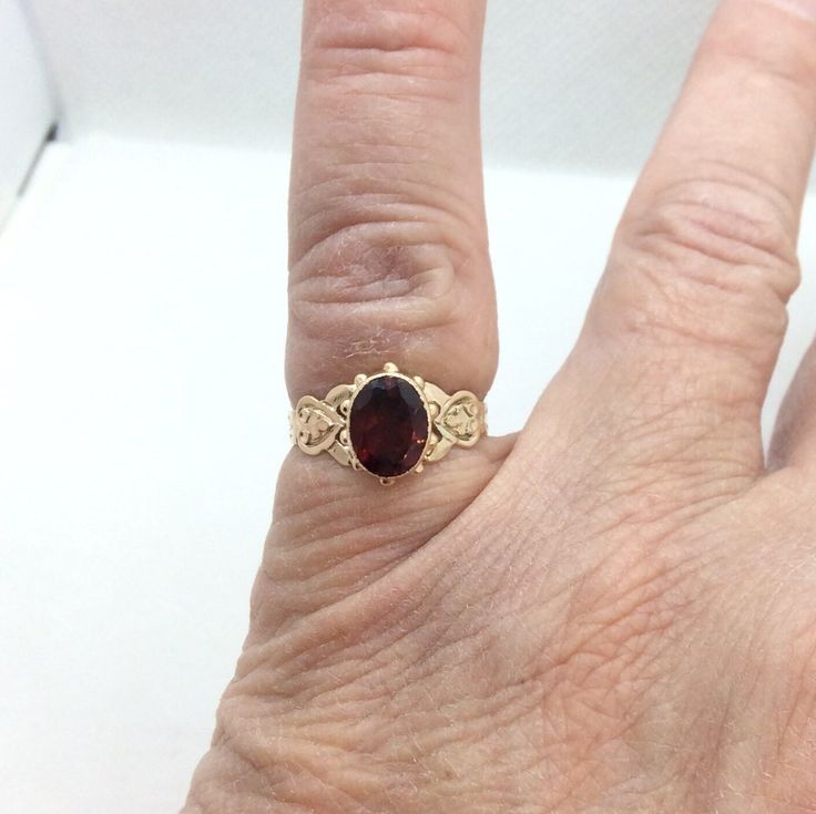 Beautiful Antique Garnet ring Victorian ring in gold  with a bezel set oval Garnet.  This ring has beautiful inverted heart shoulders in gold . This ring is a size 6 and signed but I don't know the maker. The garnet is 10 x 8 mm and the top of the ring measures 5mm x 7 mm inch  Gift Box with purchase Formal Yellow Gold Heart Ring Oval Shape, Heirloom Oval Cabochon Jewelry For Anniversary, Fine Jewelry Hallmarked Oval Cabochon Ring, Fine Jewelry Oval Cabochon Rings Hallmarked, Fine Jewelry Oval Cabochon Ring With Hallmark, Wedding Jewelry With Bezel Setting And Oval Cabochon, Fine Jewelry Yellow Gold Oval Heart Ring, Oval Heart Ring In Fine Jewelry Style, Wedding Jewelry With Bezel Set Oval Cabochon