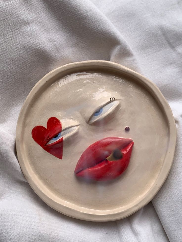 a white plate topped with two red lips