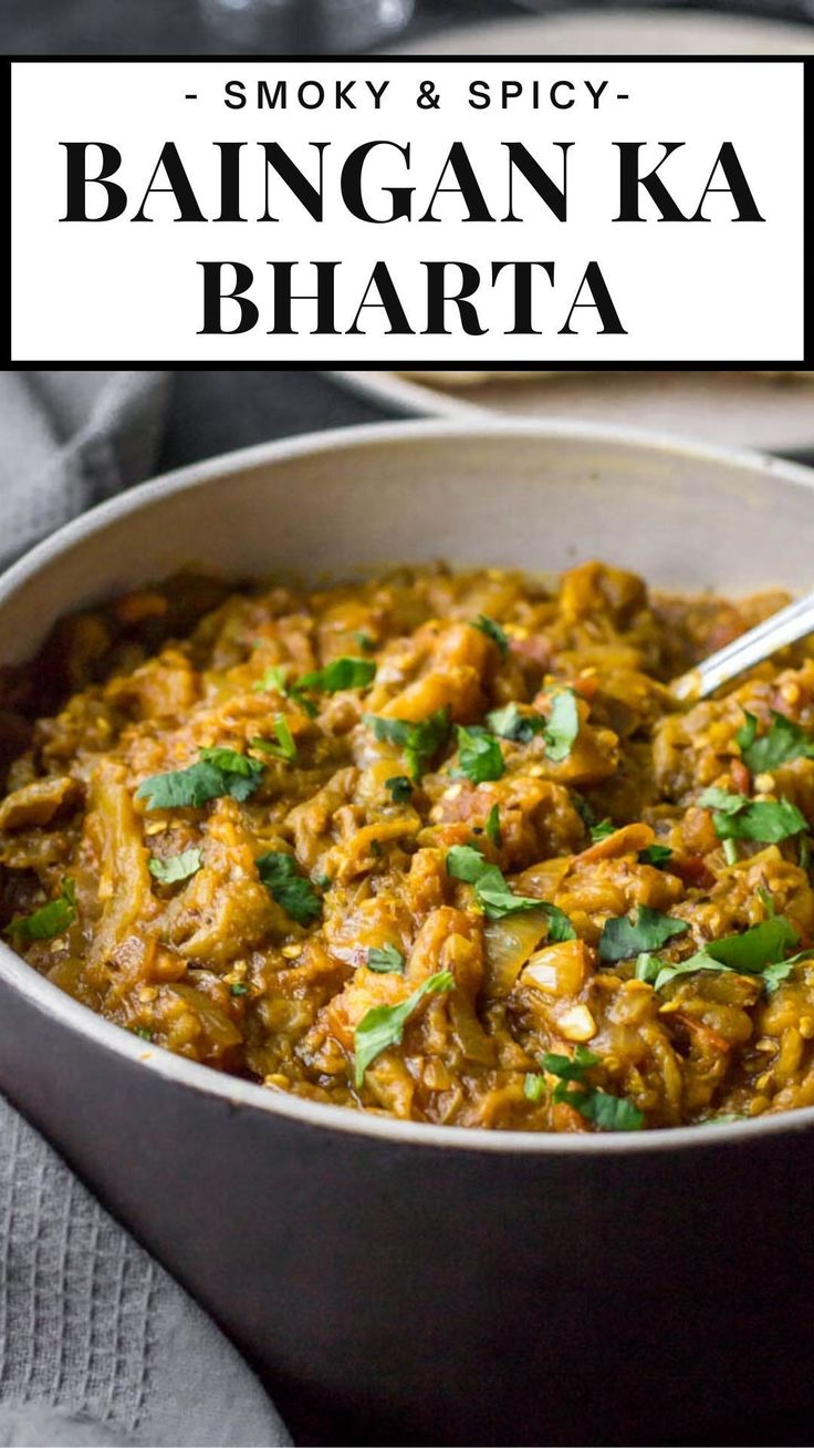 a close up of a bowl of food with a spoon in it and the words bangan ka bharta