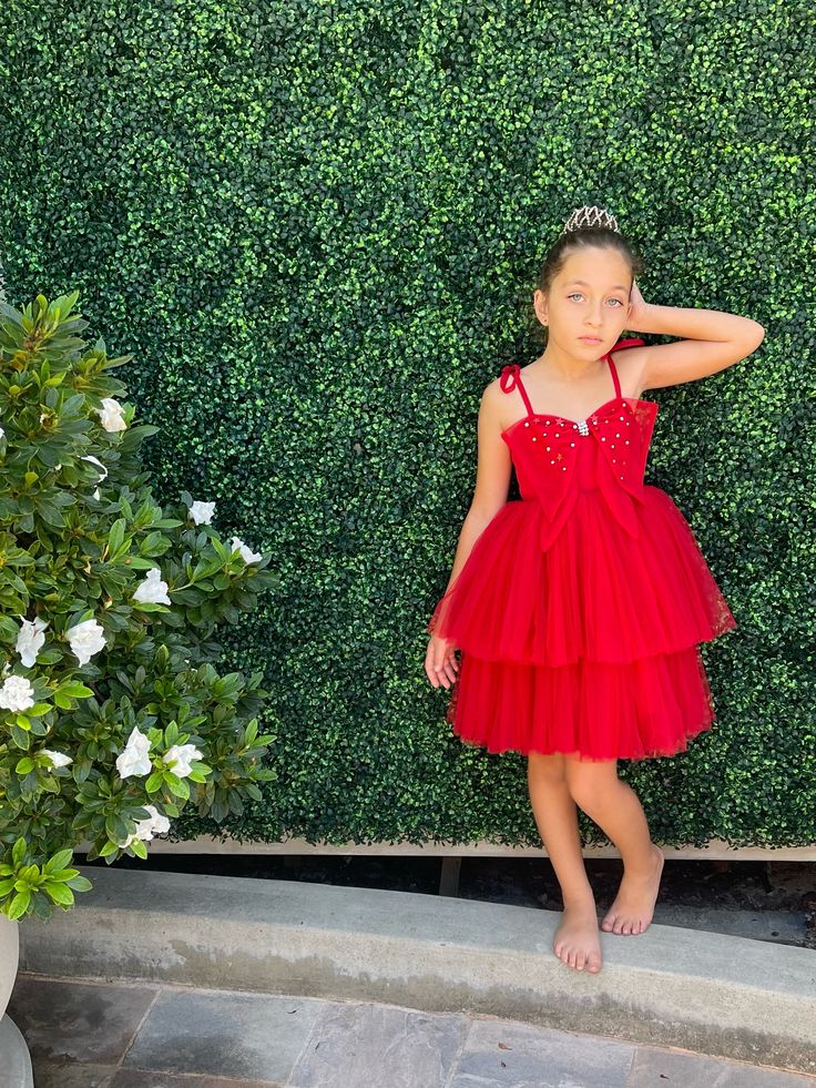 💫 in stock and ready to ship! Ruby red runway inspired babydoll dress with a large tulle bow sewn along the neckline. Signature star and pearl hand beading make this dress a truly special piece. Delicate self-tie tulle straps finish off the sweetest look! Luxe nylon tulle Cotton jersey bodice base and cotton lining Stretch panel on back and no zippers or buttons for comfort. Measurements: 1/2: 14.5” length armpit to hem, 20” chest (with some stretch) 3/4: 15.5” length, 21” chest unstretched 5/6 Cute Red Sleeveless Tutu Dress, Red Runway, Tulle Straps, Tulle Bow, Tulle Bows, Babydoll Dress, Ruby Red, Hand Beading, How To Make Beads