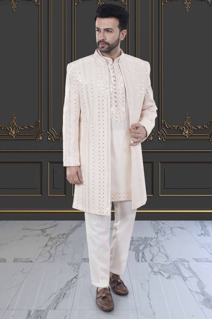 This Mens Sherwani (M42-S133) is an open jacket style with exquisite sequin and thread embroidery. The intricate detailing adds a touch of elegance to this traditional attire. Perfect for weddings and special occasions, this sherwani is a must-have for anyone looking to make a statement. Elegant Nehru Jacket With Mirror Work For Festive Occasions, Bollywood Style Formal Outerwear For Eid, Elegant Sherwani With Mirror Work And Long Sleeves, Elegant Sherwani With Mirror Work, Elegant Nehru Jacket With Dabka Work For Eid, Bollywood Style Outerwear For Eid Wedding, Wedding Outerwear With Zari Work For Eid, Zari Work Outerwear For Wedding And Eid, Elegant Nehru Jacket With Mirror Work For Transitional Season