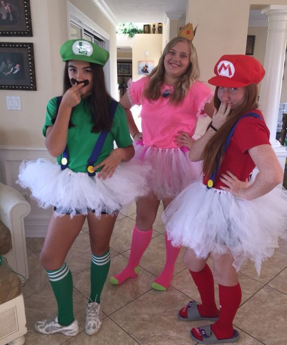 three girls dressed up as mario and princess peaches in costumes for a costume party