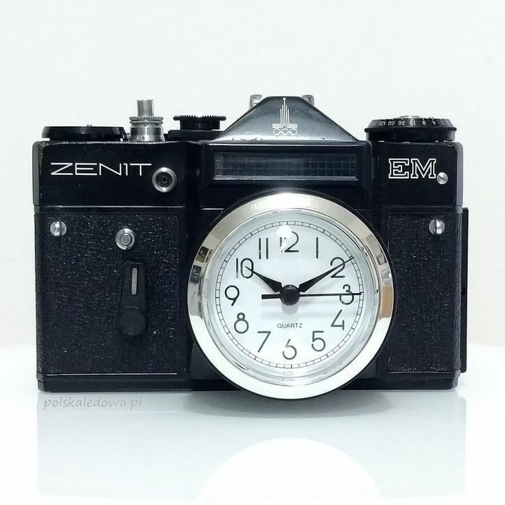 an old fashioned camera with a clock on the front