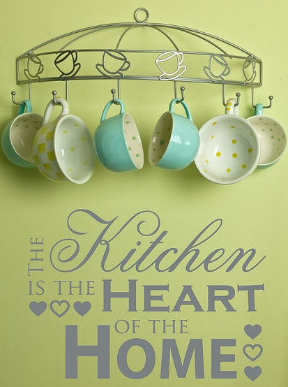 the kitchen is the heart of the home wall decal with teacups hanging from a rack