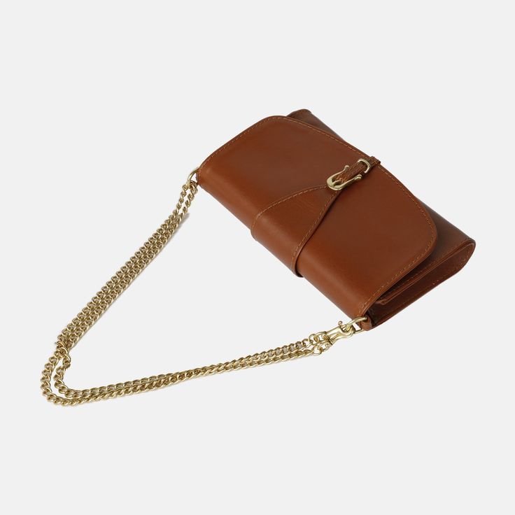 Meet our newest crossbody, The Pennington! This timeless design embodies class, organization, and ease. Made from a rich vegetable-tanned leather, it holds a structured shape for an elevated look. This multifunctional wallet is large enough to comfortably fit your phone and keys. Wear it as a crossbody with the Leather Crossbody Strap it comes with, The Chain Strap (sold separately), or as a clutch for a night out. The Pennington is made in León which has a rich history in leather-working and ta Class Organization, Veg Tan Leather, Vegetable Tanned Leather, Crossbody Strap, Leather Working, Chain Strap, Tan Leather, Leather Crossbody, Solid Brass