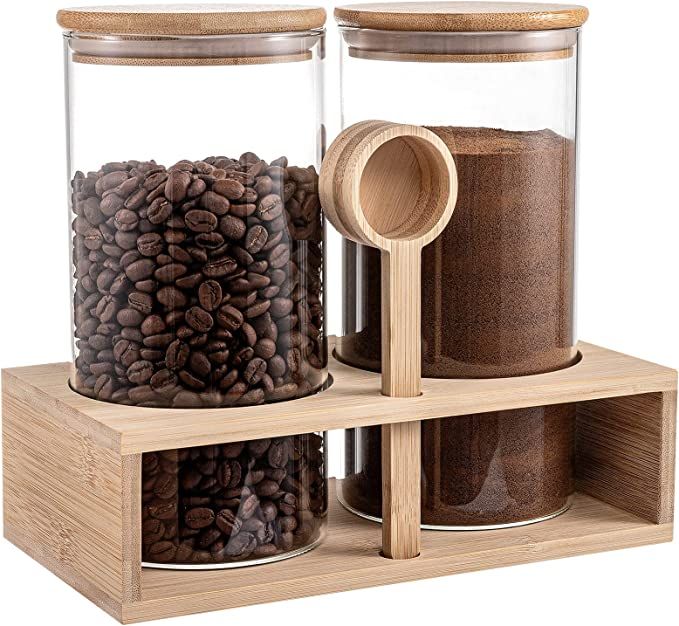 three glass jars with coffee beans in them on a wooden shelf next to each other