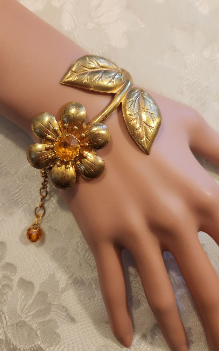 "I love this adorable bracelet! The stunning large centerpiece of this assemblage bracelet features a vintage brass 1960s-1970s figural topaz floral rhinestone brooch that has been combined with vintage Swarovski topaz crystal beads. The flower is 2\" wide t its widest points and the bracelet is 78\" to 8 1/4\" long.  It is so cute!   Our assemblage bracelets a great gift for Christmas, a birthday or an anniversary....or just buy it for yourself.   We have included free insured First Class shipp 1970s Jewelry, Topaz Crystal, Large Centerpiece, Jewelry Flower, Cute Bracelets, Vintage Jewels, Rhinestone Brooches, Flower Bracelet, Gift For Christmas