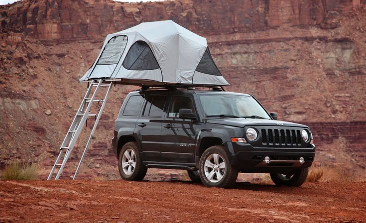 a jeep with a tent attached to the roof