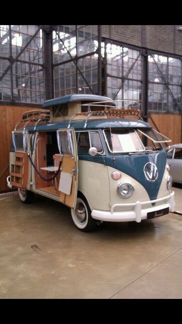 an old vw bus is parked in a garage