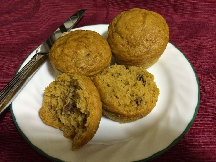 three muffins on a plate with a fork