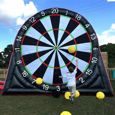 a man standing in front of a giant dart