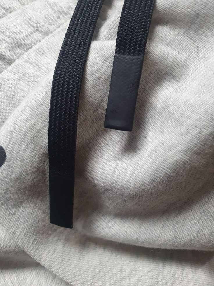 a black belt on top of a white shirt