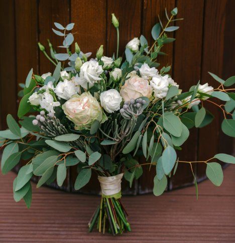 a bouquet of flowers sitting on top of a wooden table