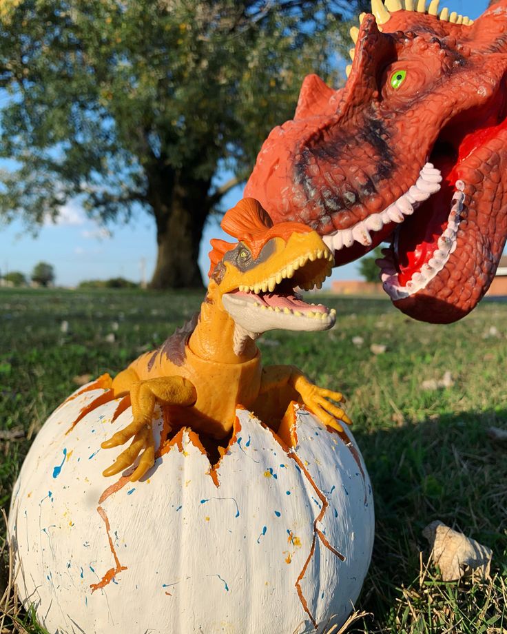 a fake dinosaur head sitting on top of a pumpkin