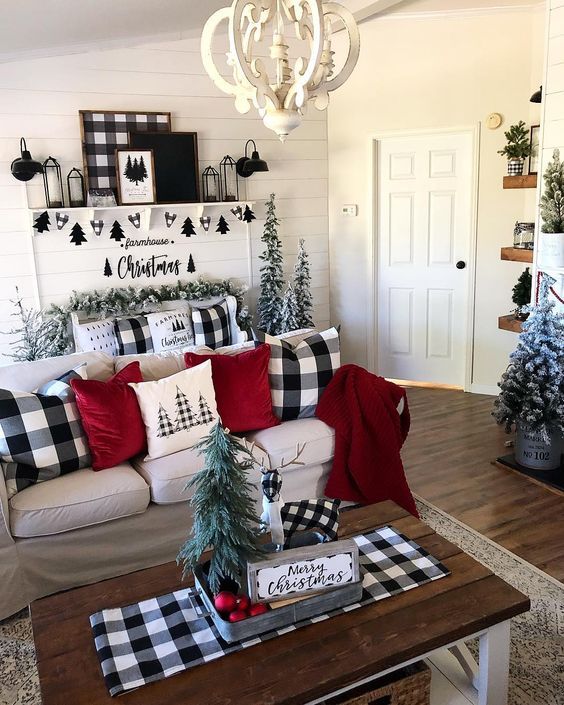 a living room filled with furniture and christmas decorations