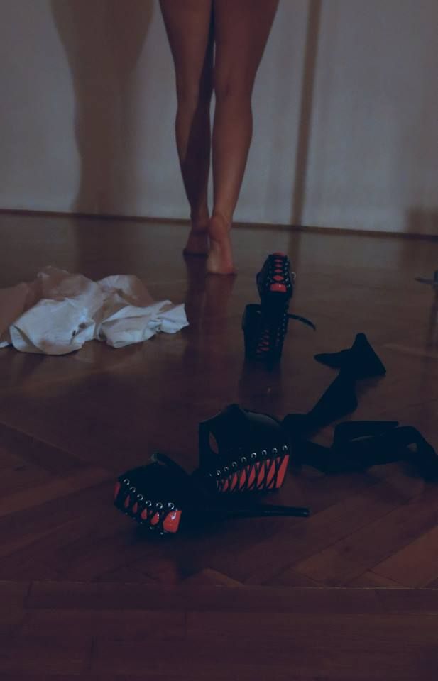 a woman's legs and shoes on the floor