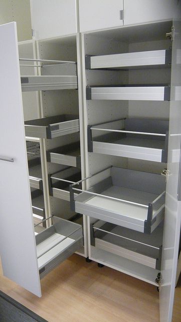 an empty pantry with shelves and drawers in it