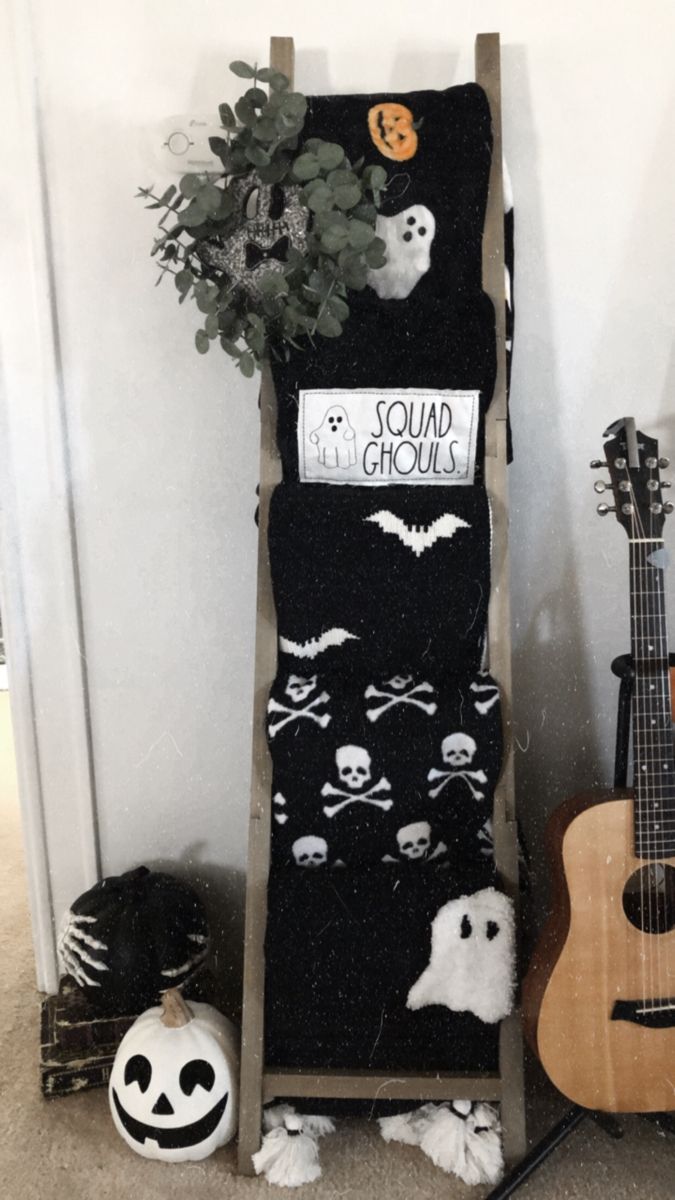 an old ladder has been decorated with halloween decorations and is next to a small guitar