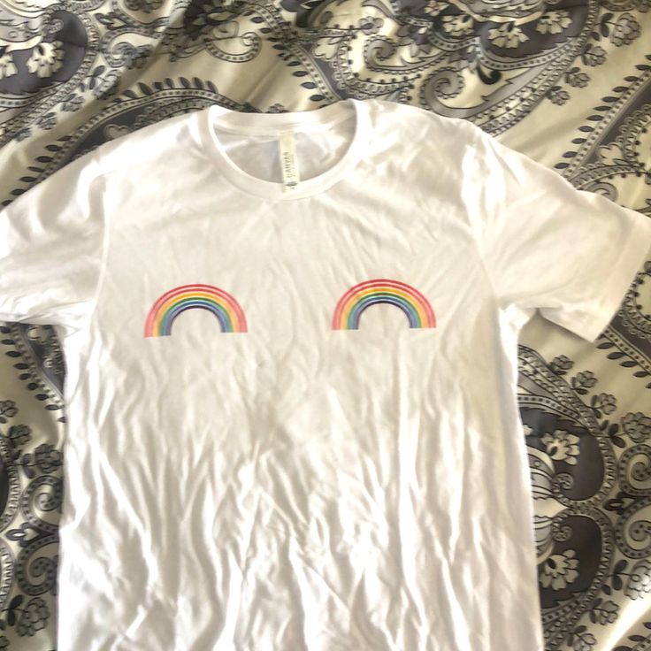 White Cotton Tshirt With Small Rainbows On Chest. Never Worn. Cotton T-shirt With Rainbow Print For Pride, Spring Rainbow Short Sleeve T-shirt, Trendy Rainbow T-shirt For Pride, Trendy Rainbow Pride T-shirt, Trendy Rainbow T-shirt For Spring, Rainbow Short Sleeve Tops With Graphic Print, Rainbow Graphic Print Short Sleeve Top, Spring Graphic Tee With Rainbow Print, Fun Rainbow Print Short Sleeve Top