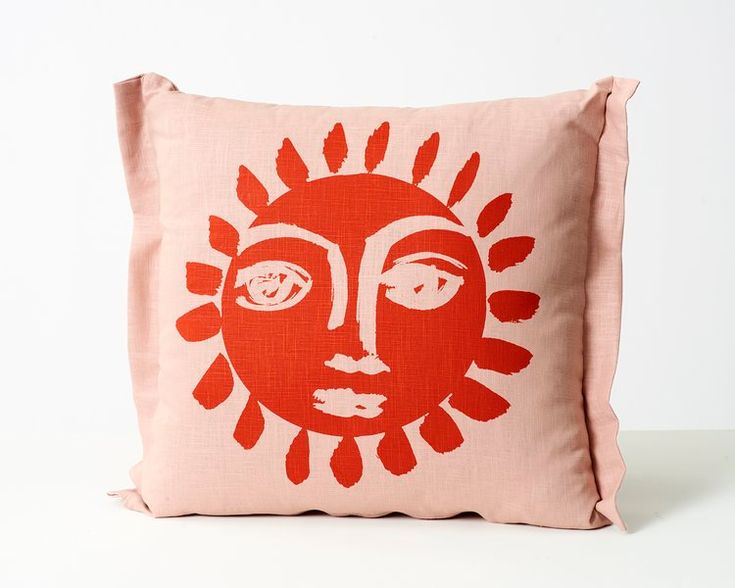 a red pillow with an image of a woman's face on it