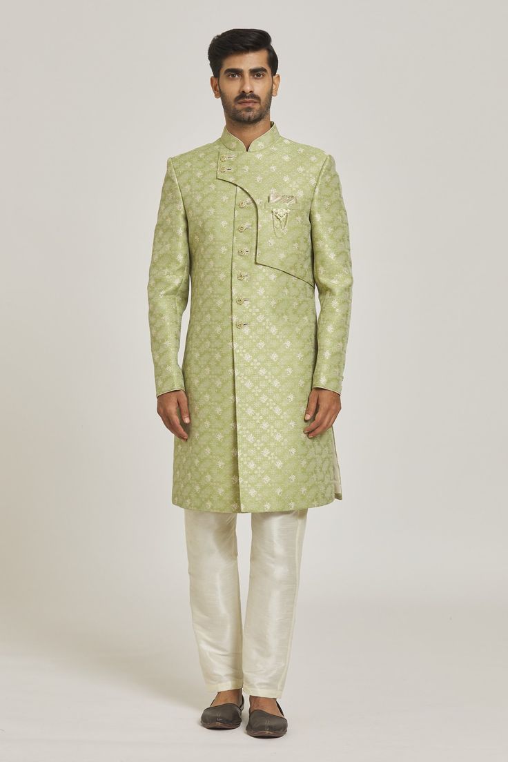 Green overlap sherwani with floral pattern and patch pocket. Paired with cream aligarhi pant.
Components: 2
Type Of Work: Floral
Neckline: Mandarin
Sleeve Type: Full
Fabric: Sherwani: Banarasi Jacquard, Pant: Dupion Art Silk
Color: Green
Other Details: 
Note: Pocket square and brooch worn by the model is not for sale
Occasion: Wedding - Aza Fashions Green Sherwani, Fashion App, Pocket Square, Aza Fashion, Sleeve Type, Patch Pocket, Floral Pattern, Types Of Sleeves, For Men