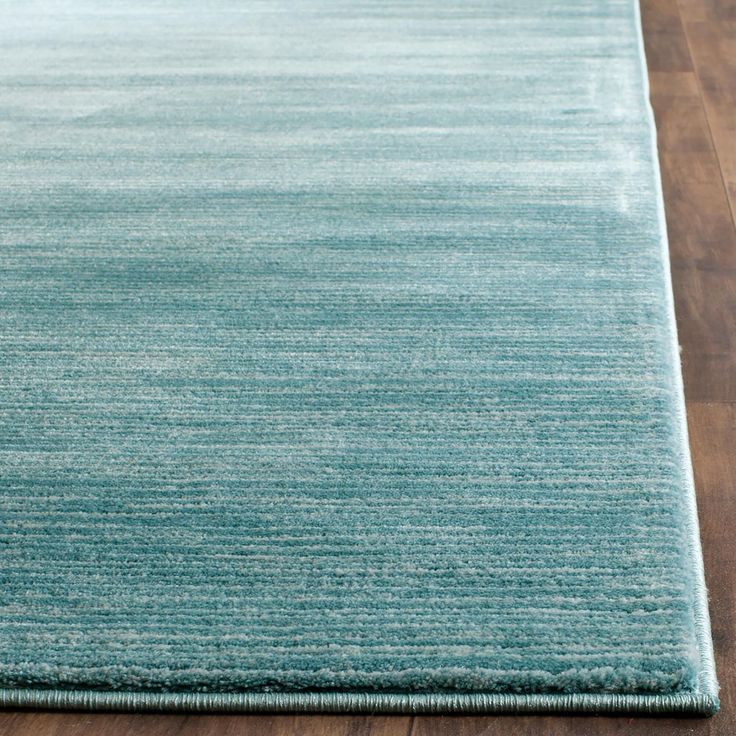 a blue rug on top of a wooden floor