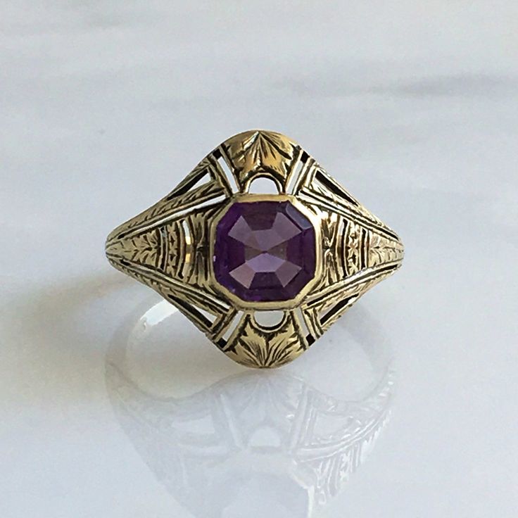 Details: Victorian 14K gold Art Deco amethyst ring circa 1930's. Beautiful deco design, with leaf inspired pattern. The lovely amethyst measures 6.7mm x 6.7mm, and sits about 5.5mm from the finger. The setting measures 15.4mm from top to bottom. The ring is in excellent condition. Please ask all necessary questions prior to placing an order. Measurements: The size is 7 US and can be sized for a fee. Condition: The overall all condition of this ring is excellent condition and the stone is securel Luxury Art Deco Purple Amethyst Ring, Classic Amethyst Ring Stamped 14k, Formal 14k Gold Purple Amethyst Ring, Formal Purple Amethyst Ring In 14k Gold, Art Deco Amethyst Ring In Yellow Gold, Art Deco Yellow Gold Amethyst Ring, Yellow Gold Amethyst Ring In Art Deco Style, Art Deco Purple Amethyst Ring For Formal Occasions, Purple Amethyst Art Deco Ring For Formal Occasions